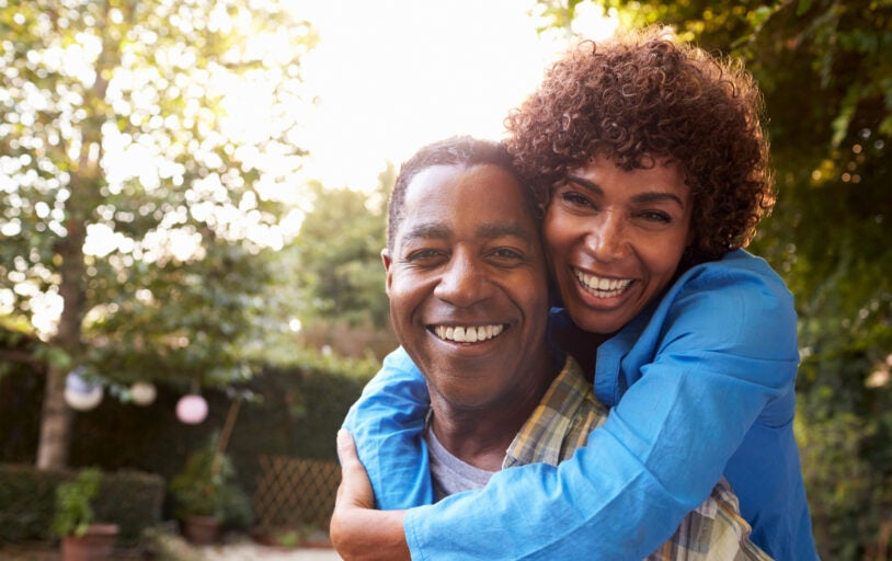 Portrait Of Loving Mature Couple In Back Yard Garden