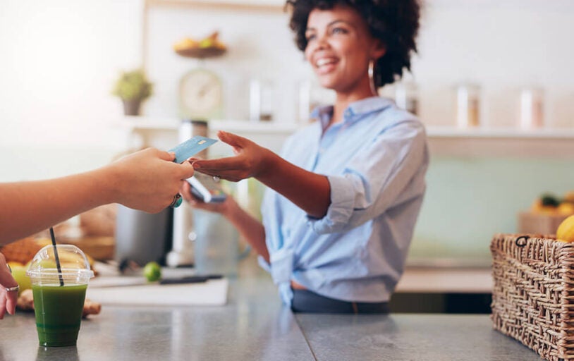 Woman business owner accepting credit card from customer