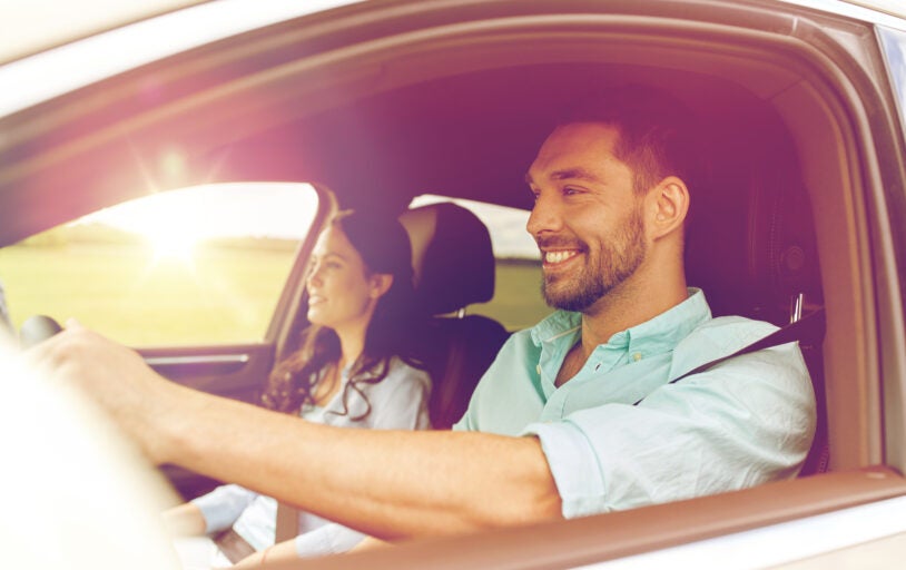 Couple driving around smiling