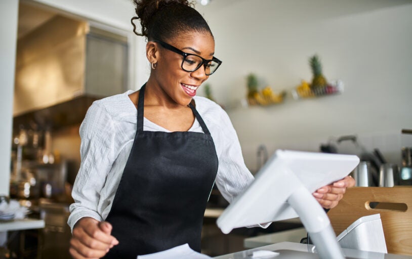 Woman using modern checkout station