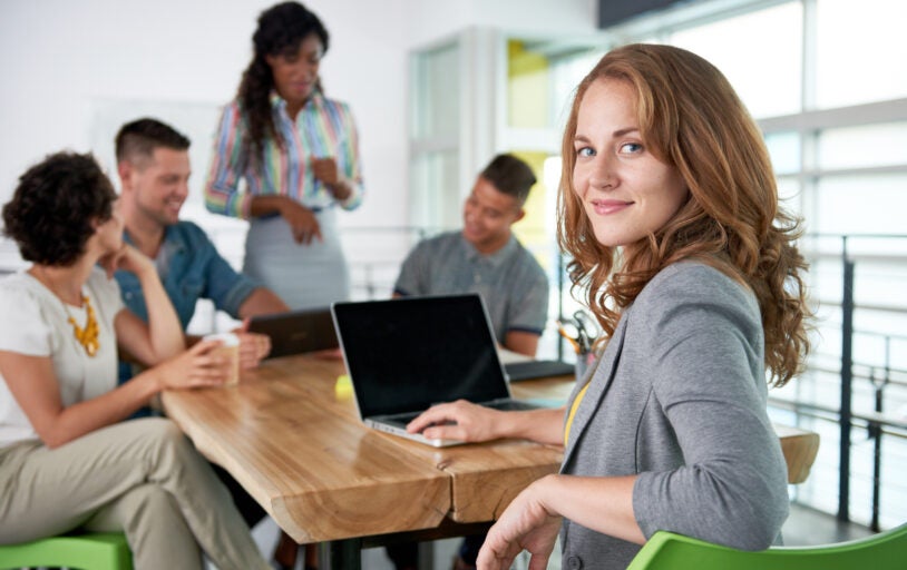 Woman smiling at conference table