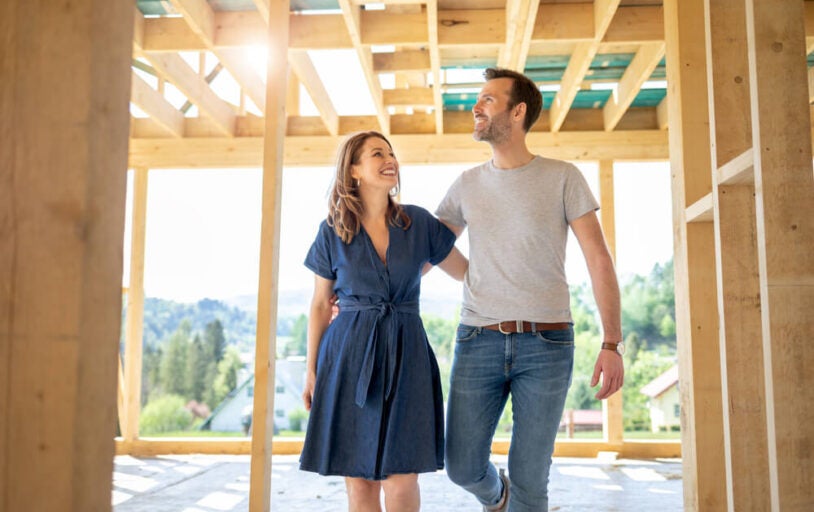 Family walking through their framed home