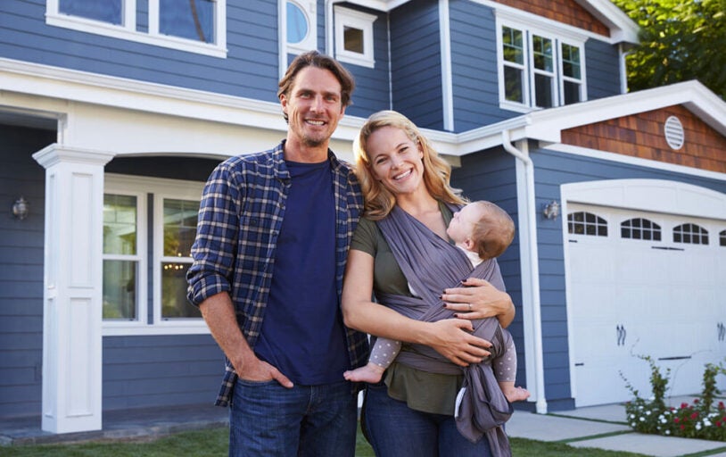 Family in front of new home