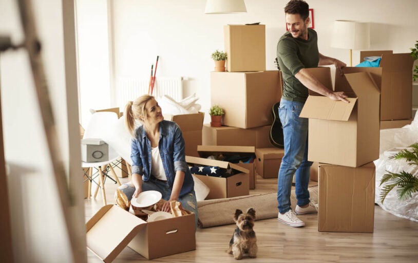 Happy Family unpacking boxes